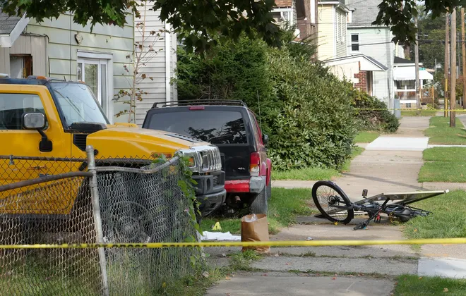 Nine people died in a reported shooting in and around a home at 722 Perry St., far left, in Erie, Pa., Oct. 9, 2026. Erie Bureau of Police investigators were on the scene Oct. 10.