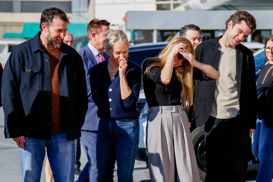 The Pitt stars Noah Wyle, Katherine LaNasa, Taylor Dearden and Patrick Ball admire a chalk mural of the cast at outside Allegheny General Hospital.