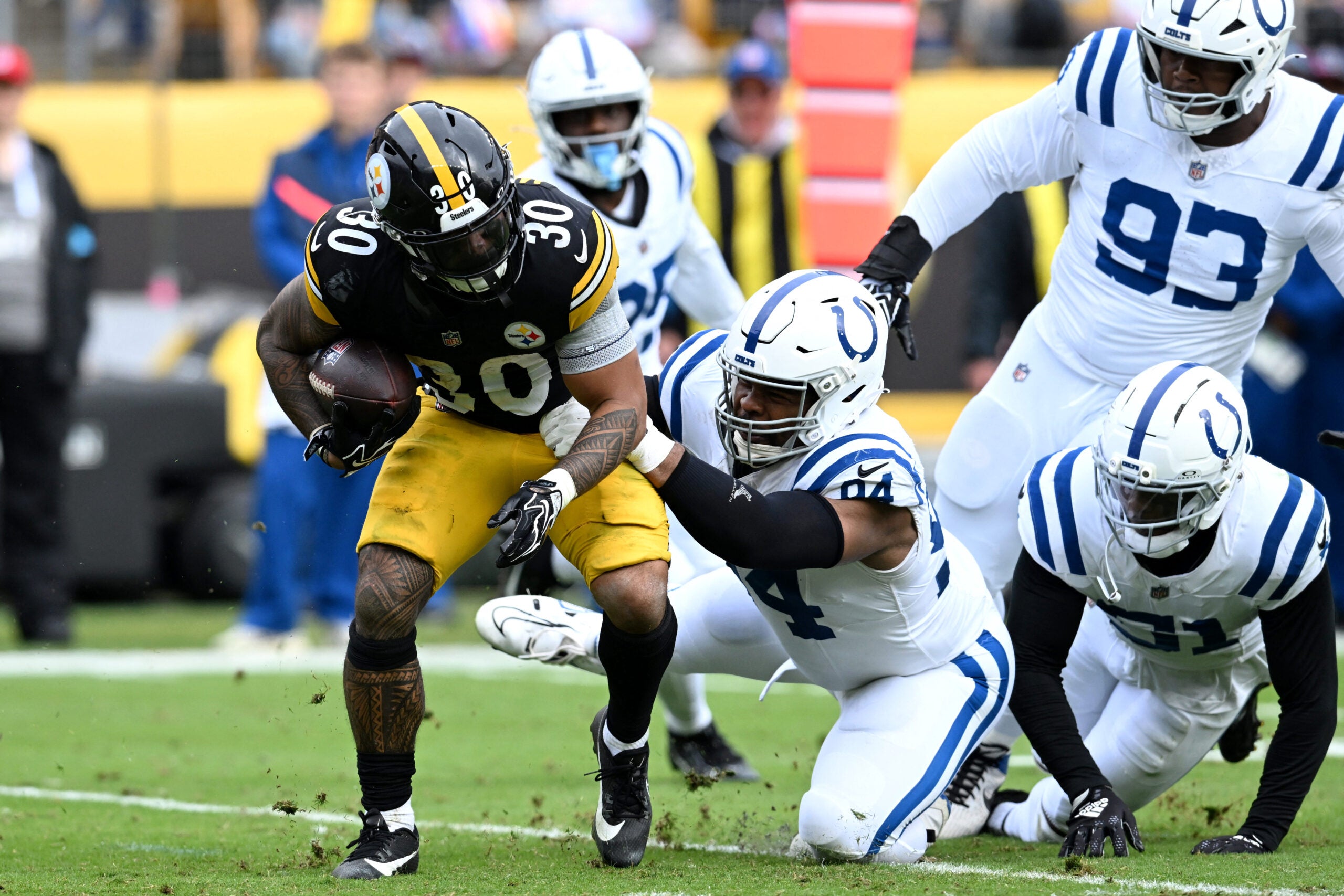 Oct 11, 2026; Pittsburgh, Pennsylvania, USA; Pittsburgh Steelers running back Jaylen Warren (30) is tackled by Indianapolis Colts defensive tackle Jerry Tillery (94) in the second quarter at Acrisure Stadium.