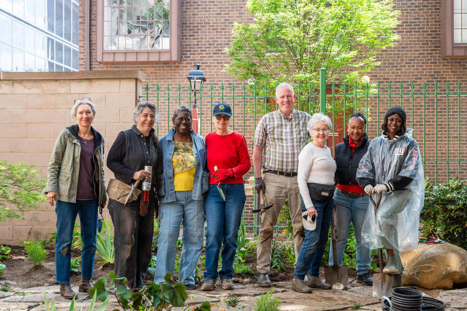 Volunteer planting are shown at The Anthenaeum with community garden leaders and landscape designer Wambui Ippolito.