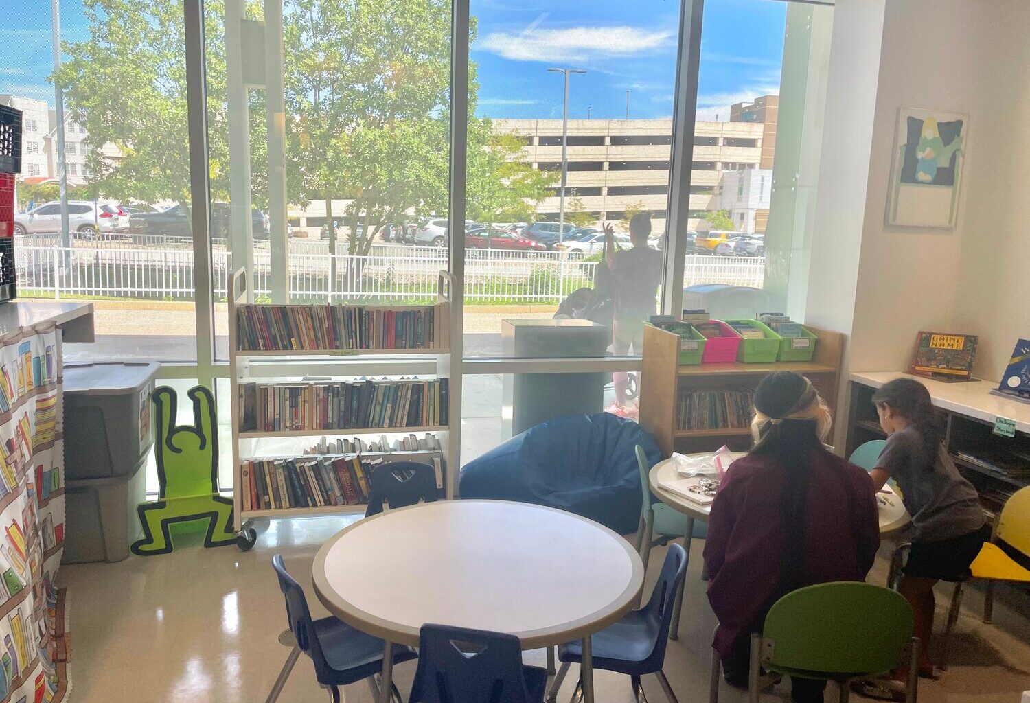 Five-year-old Elina draws and writes with a volunteer at St. Christopher&rsquo;s Hospital. &ldquo;I can tell you, when I go somewhere, she always takes me to the toys, not the books. But when she actually gets a book, that&rsquo;s very helpful,&rdquo; says her mother, Elizabeth.