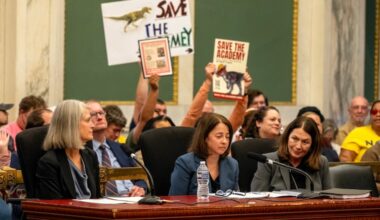 Melissa Richman (center), Drexel's executive director of operations, testifies as City Council holds a hearing on the closure of the museum at the Academy of Natural Sciences and the Academy's ongoing negotiations with Drexel. At left is Suzanne Biemiller, Academy board president.