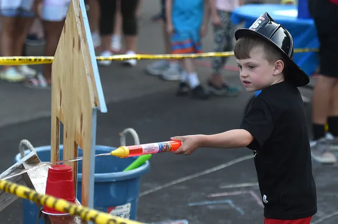Brantlee Jones, 5, of Millcreek Township maneuvers through an obstacle course during the National Night Out event on Aug. 3, 2021 at the Belle Valley Fire Department in Millcreek Township.