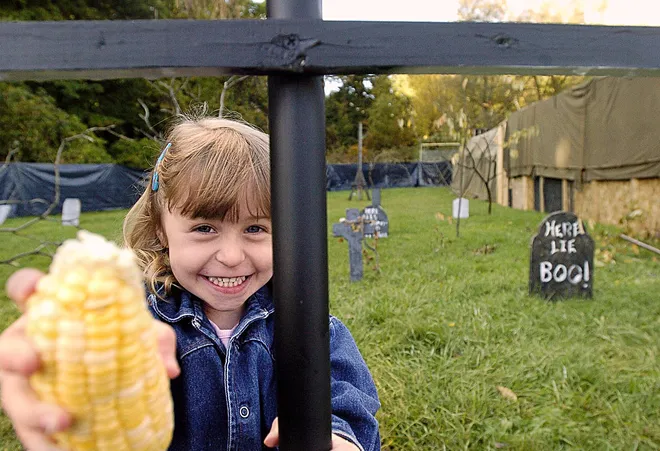 Kensley Semple, 3, stands in the makeshift graveyard which is part of the haunted house exhibit at the Belle Valley Fire Department on Oct. 3, 2004.