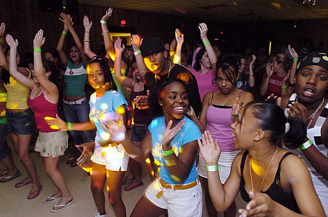 (back row right) Tim Jordan, 16, (front row from right) Latoya Simpson, 15, Danica Bowan, 15, and Sanyika Rowan, 14, dance at the Belle Valley Fire Hall on Sunday, July 10, 2005.