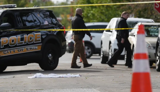 Erie Bureau of Police investigate the scene where multiple people were killed in a reported shooting in and around a home at 722 Perry St. in Erie, Pa., Oct. 9, 2026.