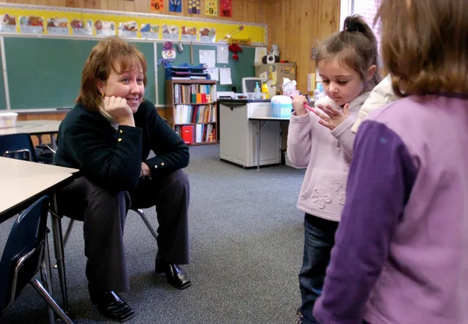 Blessed Sacrament kindergarten teacher Kate Kapp talks with Anjelina, center, and Isabella Didion during the school's open house in January 2007. See years of photos from Blessed Sacrament School in Erie PA