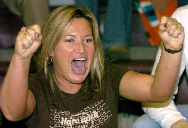 Cathedral Preparatory School teacher Colleen Maxson cheers for one of her students who was swimming in a meet against McDowell in December 2006.