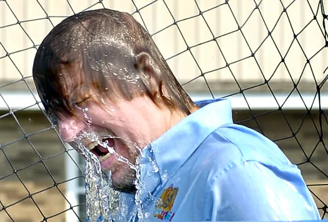 Central Tech commercial arts teacher Joe Koval emerges from a dunk tank after one of the students hit the target with a baseball in May 2007. The school raised more than $12,000 to help fund John Kanzius Research Foundation cancer research.