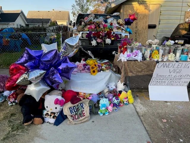 Family, friends and visitors from all around contributed balloons, stuffed animals, candles and flowers to the memorial set outside 722 Perry St. It was at this scene a tragic mass shooting event took place on Oct. 9, 2026.