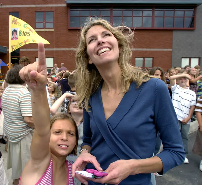 Iroquois Elementary School fourth-grade student Moss LeVan and her teacher, Kasey Smith, watch the flight of helium-filled balloons that were released in celebration of the opening of the new school in September 2007.
