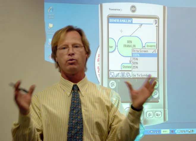 John Wasiulewski, a social studies teacher at Harding Elementary School, teaches his class of 30 students how to find information on Ben Franklin on their Palm Tungsten E2 hand-held computers on Nov. 2, 2007. Inside Harding Elementary and its role in west Erie PA