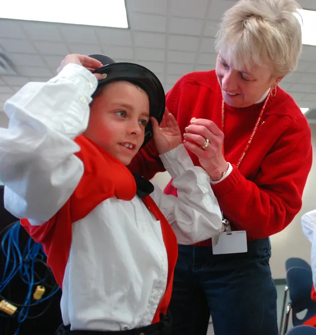 Music teacher Judy Kosik assists second-grader Christopher Slawson, 8, with his elf hat during dress rehearsal for the holiday show "Evening with the Elves" at Asbury Elementary School on Nov. 29, 2007. Second-graders performed the show Nov. 30 and Dec. 21.