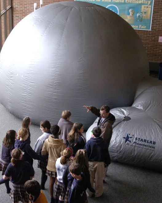 Villa Maria Elementary teacher Scott Strosser leads his sixth-grade class into the Starlab, a portable planetarium, set up in the school's lecture hall on April 1, 2008.