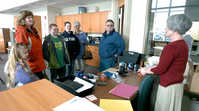 J.S. Wilson Middle School students and parents talk with sixth-grade teacher Ardis Walsh, right, during an open house at the new facility March 13, 2008. The families, from left, are Grace Dill, 8, Merritt Dill, Jack Dill, 11, Kristin LaCross, 12, with her grandmother Mary Ann Smith, and Tom Dill.