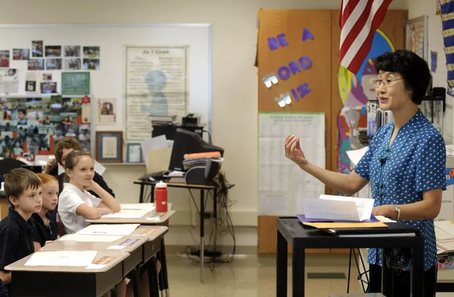 Quing Liang, right, Mandarin teacher at JoAnna Connell Elementary in Erie, goes over some essential greetings with Laurie Hogan's fifth-grade class on Sept. 18, 2008. Liang also taught Mandarin at Harding Elementary, serving a total of more than 400 students between the two schools.