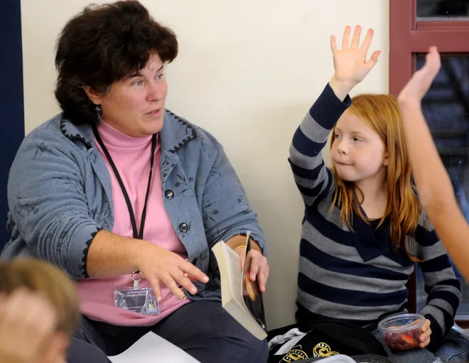 Julie McGaughey, discovery teacher at Wattsburg Area Elementary, in Greene Township, leads Ashley Hoover, 9, and her fourth-grade classmates in a discussion about the book "The City of Ember" by Joanne DuPrau on Oct. 7, 2008. The students volunteered to be in a book club where they interacted with each other and administrators and talked about a specific book.