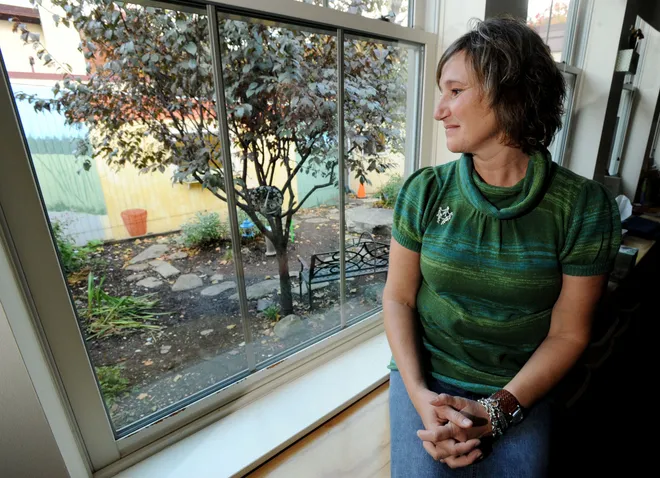 Ann Giannelli, a third-grade teacher at Erie Day School, views the garden she and her students created from inside her classroom on Oct. 21, 2008.