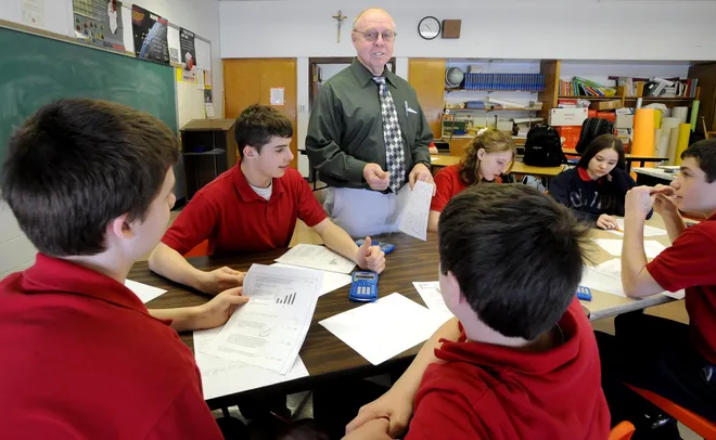 Our Lady of Mt. Carmel School math teacher Patrick Brickner discusses math problems Feb. 18 , 2009, with some of his students, clockwise from left, Owen Beaufort, Thomas Higgins, Emma Weisenfluh, Erika Woll, Jordan Vroman and Chris Martone.