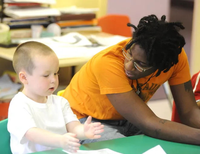 Randall Harris, group supervisor and preschool teacher at the Martin Luther King Day Care, works with Nathan McQuade, 3, during a class on July 21, 2009.