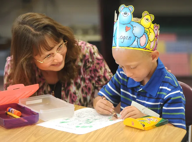 Springfield Elementary School kindergarten teacher Heidi Vanicek greets Logan Addicott, 5, one of her students, on the first day of classes on Aug. 26, 2009.