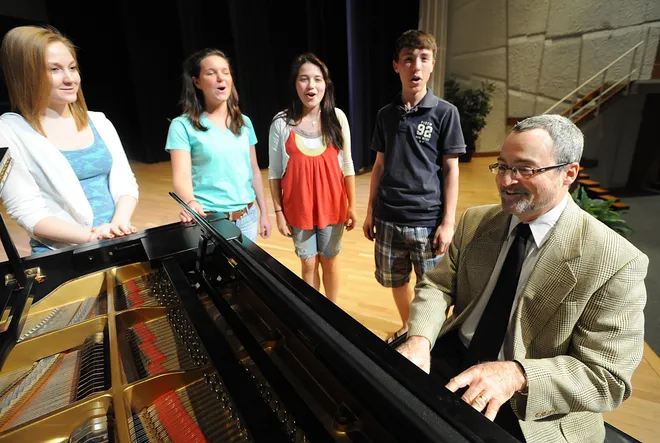 McDowell High School music teacher and Performing Arts Center director Michael Malthaner, at piano, was one of 12 finalists for Pennsylvania Teacher of the Year in 2009. Malthaner was working with students, from left, senior Olivia Vaughn, juniors Megan Ott and Alexandra Schwartz, and sophomore Dominic Barbaro at the school in Millcreek Township on May 20, 2009.