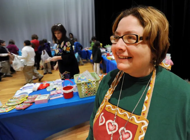 Harding Elementary School Title 1 teacher Patty Zielewski runs the Gingerbread Shop while students shop for gifts for their relatives Dec. 17,  2009.