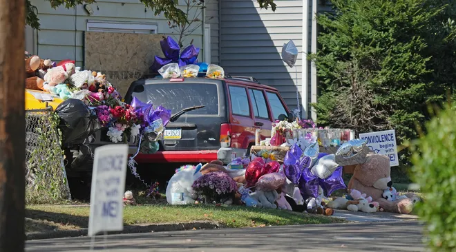 A memorial for victims of a mass shooting attracts curious onlookers at 722 Perry St. in Erie, Pa., Oct. 13, 2026. The shooting took place on Oct. 9.