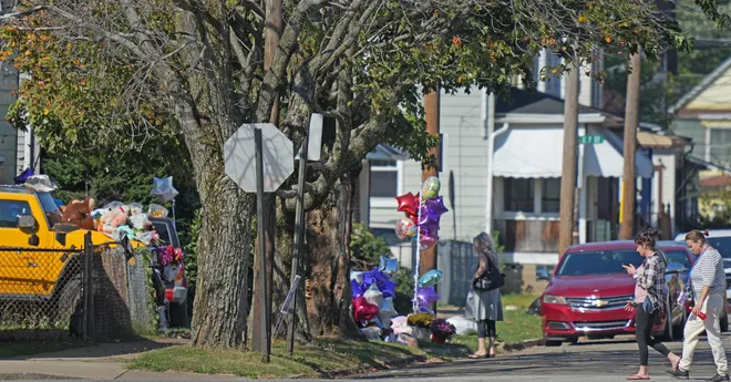 A memorial for victims of a mass shooting attracts onlookers at 722 Perry St. in Erie, Pa., Oct. 13, 2026. The shooting took place on Oct. 9.