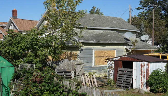 The view of a nearby neighbor looks at the south side of 722 Perry St., site of a mass shooting in Erie, Pa., Oct. 13, 2026. Nine people were killed before the gunman shot himself.