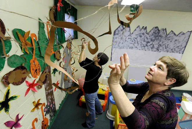 The staff at Lakewood Preschool doesn't let their children forget the work they've done. "When the kids come in and see this art, their eyes will be big and they'll be surprised," says Linda Pentz, 61, a teacher's aide at Lakewood Preschool for 15 years, shown hanging paper snakes in her room April 16, 2010, with teacher Tiffany Mays, background. As they'd done for over 30 years, Lakewood Preschool hold their spring art show. Teachers and aides at the Millcreek Township school decorate three classrooms with artwork completed throughout the school year, focusing the displays on themes the 45 pre-K students have learned about, including jungles, forests, dinosaurs and the circus. "The kids learn through the art that they do and that's really the fun part -- watching them learn all the things that they learn about the habitats and the animals," says Pentz.