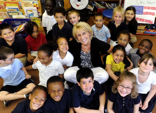 Mary Beth Abbott, a kindergarten teacher at Irving Elementary School, in Erie, poses with her class on May 28, 2010. Abbott was retiring after 40 years as a kindergarten teacher.