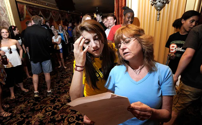 Mercyhurst Prep senior Anna Bartko, 17, left, looks over the alphabetical processional list with Carla Betti May 27, 2010, at the Warner Theatre. Bartko and 155 of her senior classmates were set to graduate May 28 at the Warner, kicking off the region's high school commencement season. Betti was a Mercyhurst Prep senior homeroom teacher who had known most of the students for their entire high school experience.