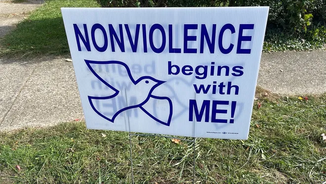 Around the 700 block of Perry Street on Oct. 13, signs stating "nonviolence begins with me" were placed near 722 Perry St., the site where a mass shooting took place Oct. 9, 2026. Nine individuals, including an unborn baby, were killed.