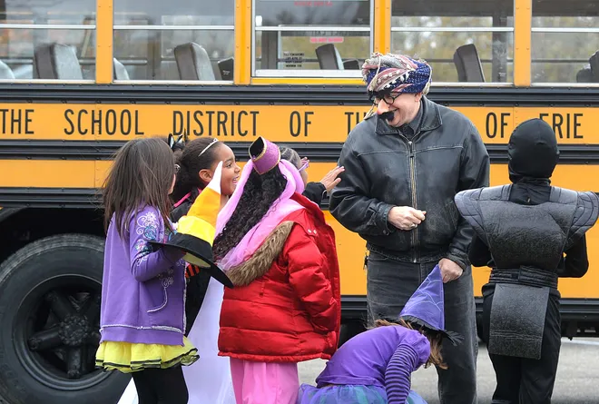Steve Colantti, music teacher at Harding Elementary School, laughs with some of his students during a Halloween parade around the school on Oct. 29, 2010.