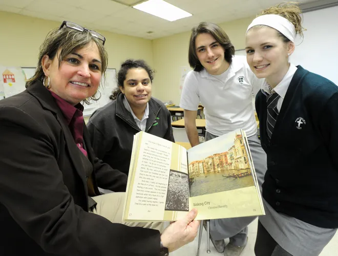 Bridget Whalen, English teacher at Mercyhurst Preparatory School, and advisor for the student literature magazine Chrysalis, shows the award-winning magazine at the school Jan. 26, 2011. Alongside her are editors, from left, Jocelyn Masci, Eddie Baxter and Jenna Bekeny, editor-in-chief.