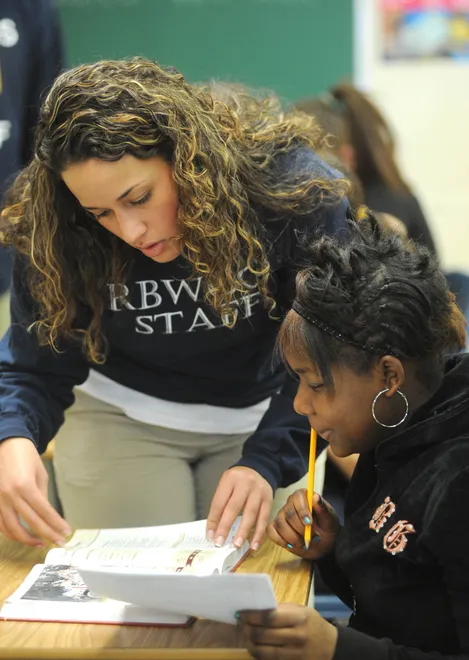 Carrie Thomas, eighth-grade social studies teacher at the R. Benjamin Wiley Charter School, in Erie, works with student Quanquil McCray, 14, on March 21, 2011.