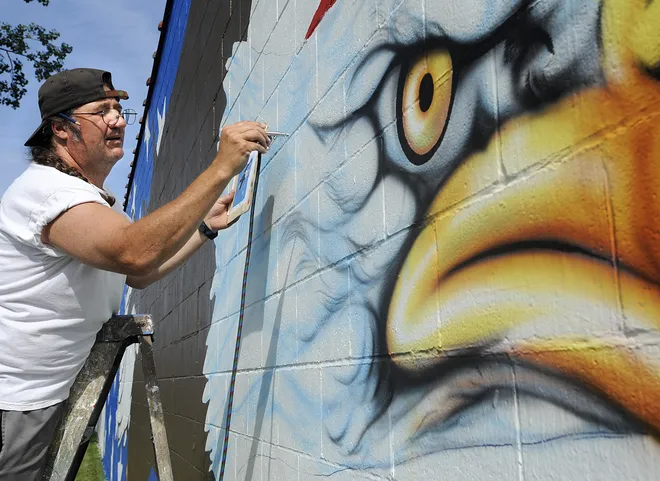 George Humes, an art teacher at Harbor Creek High School, airbrushes the eagle's feathers onto the mural on the south side of Braendel Painting and Services building on June 30, 2011. In case you missed GoErie's first teachers photo gallery: Remember these Erie County teachers? Volume 1 of our photo series