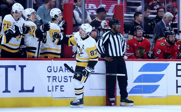 Pittsburgh Penguins center Sidney Crosby (87) is congratulated by his teammates after scoring a goal in the first period of a game against the Chicago Blackhawks at the United Center in Chicago on Oct. 13, 2026. (Chris Sweda/Chicago Tribune)