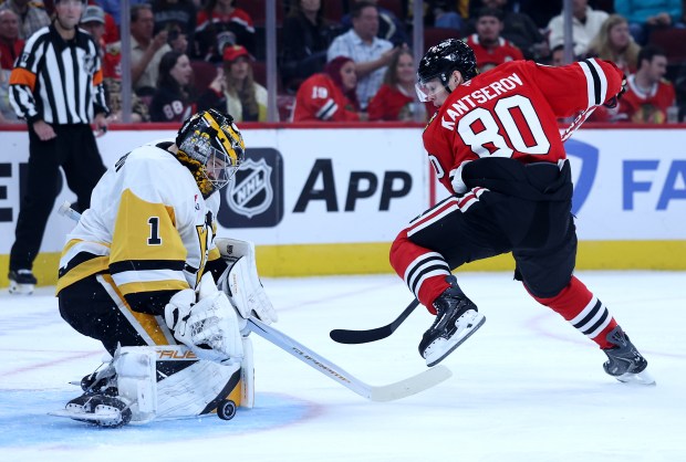 Pittsburgh Penguins goaltender Sergei Murashov (1) blocks a shot as Chicago Blackhawks right wing Roman Kantserov (80) tries to score in the first period of a game at the United Center in Chicago on Oct. 13, 2026. (Chris Sweda/Chicago Tribune)