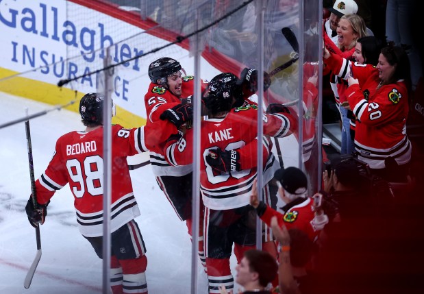 Chicago Blackhawks players Connor Bedard (98), Artyom Levshunov (second from left), and Patrick Kane (88), celebrate with Roman Kantserov after Kantserov scored a goal in the second period of a game against the Pittsburgh Penguins at the United Center in Chicago on Oct. 13, 2026. (Chris Sweda/Chicago Tribune)