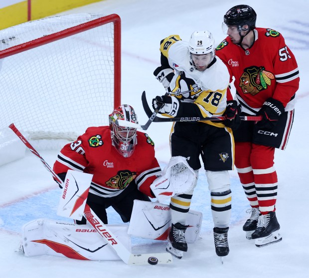 Chicago Blackhawks goaltender Spencer Knight (30) blocks the puck away in the second period of a game against the Pittsburgh Penguins at the United Center in Chicago on Oct. 13, 2026. (Chris Sweda/Chicago Tribune)