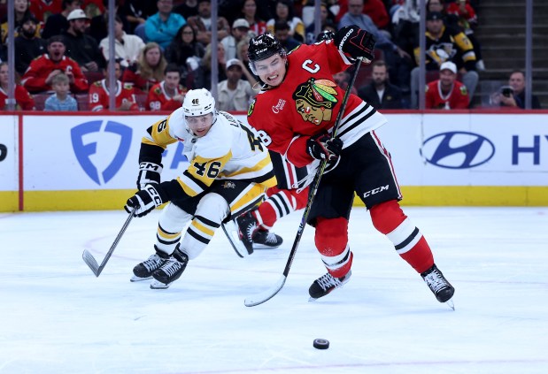 Chicago Blackhawks center Connor Bedard (98) tries to gain control of the puck in the third period of a game against the Pittsburgh Penguins at the United Center in Chicago on Oct. 13, 2026. (Chris Sweda/Chicago Tribune)
