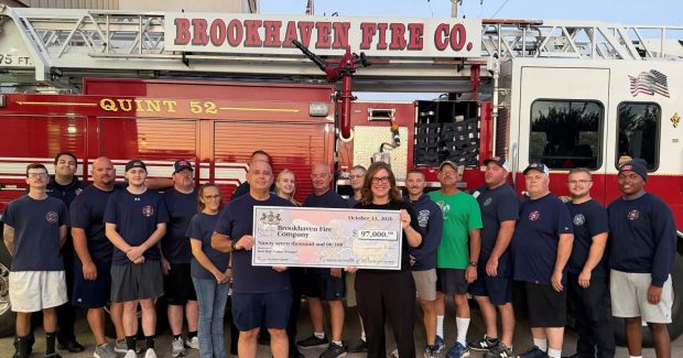 State Rep. Leanne Krueger presents $97,000 to the members of the Brookhaven Fire Company to upgrade the station's aging generators. (COURTESY OF BROOKHAVEN FIRE COMPANY)