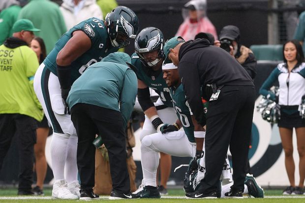 Running back Saquon Barkley (26) of the Philadelphia Eagles is evaluated by the medical staff during the first quarter against the Los Angeles Rams at Lincoln Financial Field on Sunday, Oct. 4, 2026. (Emilee Chinn/Getty Images)