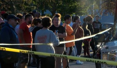 In this image from video provided by WJET, bystanders gather outside the scene of a shooting in Erie, Pa., on Friday evening, Oct. 9, 2026.