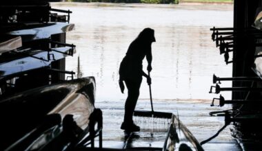 Jen Wesson cleans mud out of the University Barge Club boathouse in the aftermath of the 2020 version of Isaias. This one shouldn't be as disruptive.