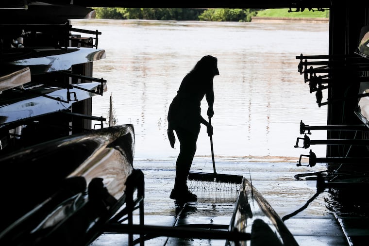 Jen Wesson cleans mud out of the University Barge Club boathouse in the aftermath of the 2020 version of Isaias. This one shouldn't be as disruptive.