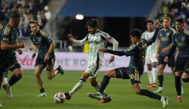 Midfielder Carles Gil dribbles past Philadelphia Union defender Nathan Harriel as the Revolution won 2-1 on Saturday, Oct. 24.