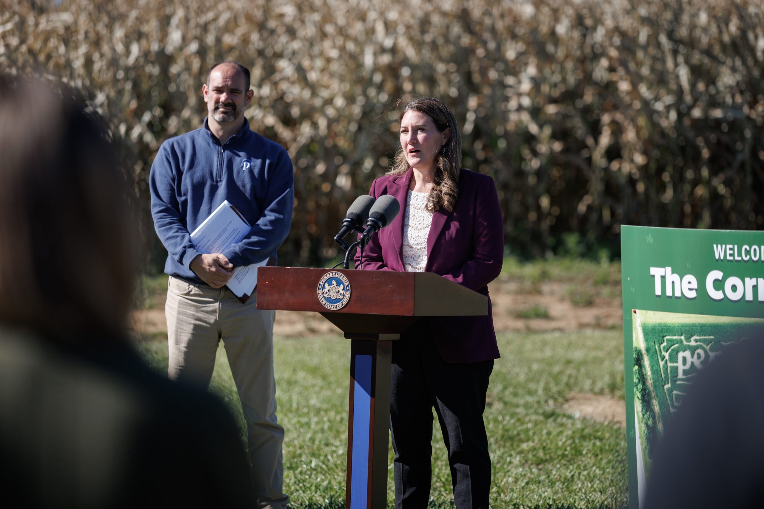 Devon Trolley speaks at a podium next to Michael Humphreys